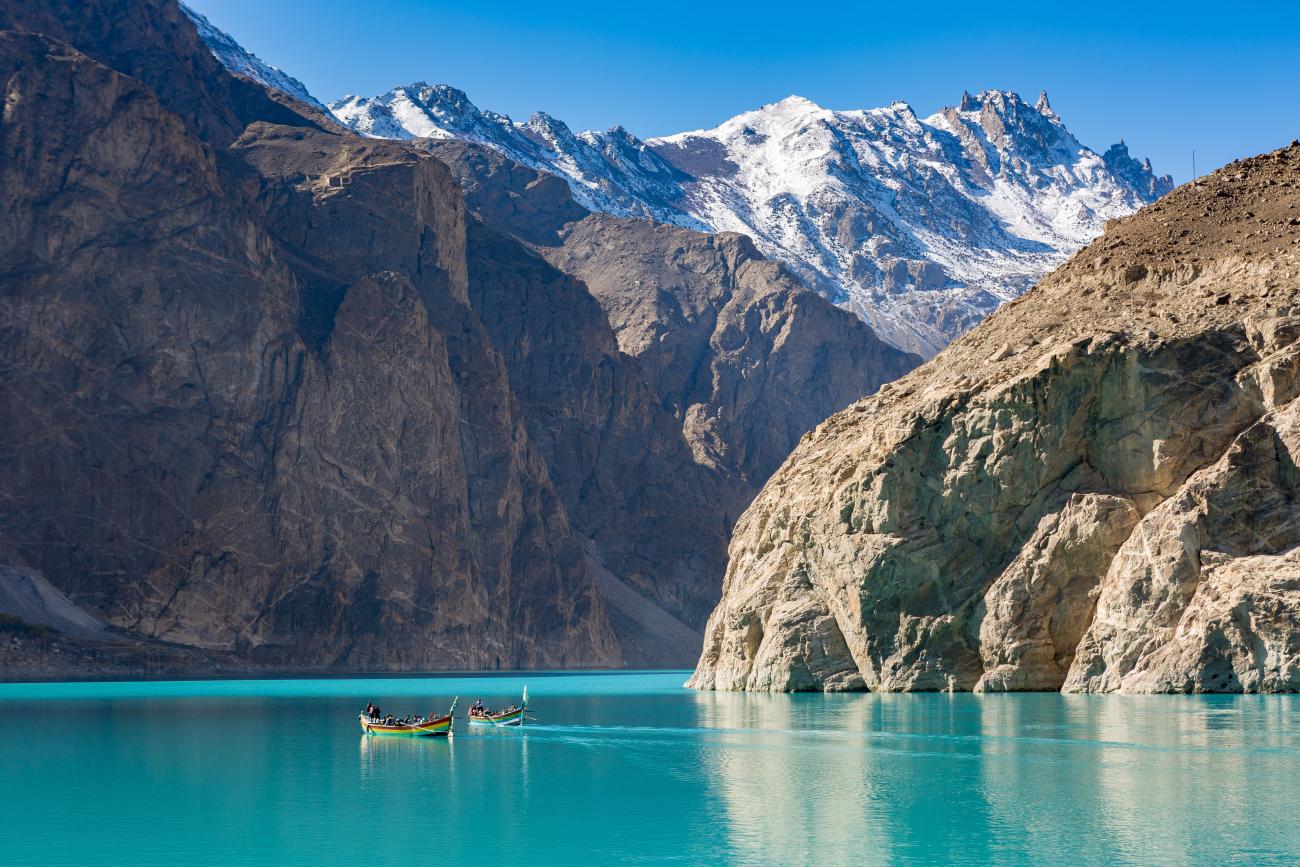 View of Lake Attabad with snow peaked mountain the background. Hunza Valley, Pakistan